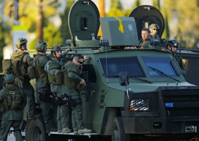 Police officers conduct a manhunt after a mass shooting in San Bernardino, California December 2, 2015. Gunmen opened fire on a holiday party on Wednesday at a social services agency in San Bernardino, California, killing 14 people and wounding 17 others, then fled the scene, triggering an intense manhunt and a shootoutout with police, authorities said.