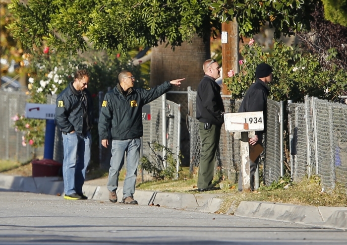 FBI and police continue their investigation in the neighborhood near the SUV vehicle in which two suspects were shot following a mass shooting in San Bernardino, California, December 3, 2015. Authorities on Thursday were working to determine why Syed Rizwan Farook 28, and Tashfeen Malik, 27, who had a 6-moth old daughter together, opened fire at a holiday party of his co-workers in Southern California, killing 14 people and wounding 17 in an attack that appeared to have been planned.