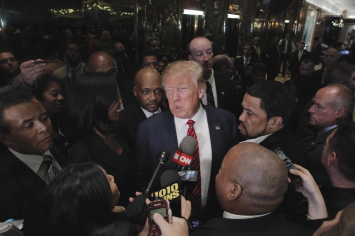 Presidential candidate Donald Trump (C) speaks after meeting with a group of black pastors at his office in the Manhattan borough of New York November 30, 2015.