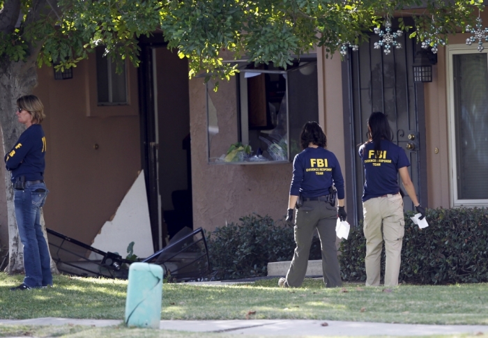 FBI agents search outside the residence that is in connection to the shootings in San Bernardino, California, December 3, 2015. Authorities on Thursday were working to determine why a man and a woman opened fire at a holiday party of his co-workers in Southern California, killing 14 people and wounding 17 in an attack that appeared to have been planned.