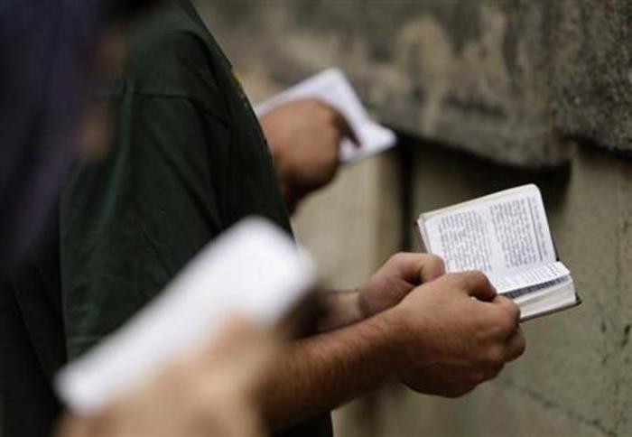 Believers read the bible during a religious service marking the Day of the Virgin Mary at Sioni Cathedral in Tbilisi August 28, 2011.