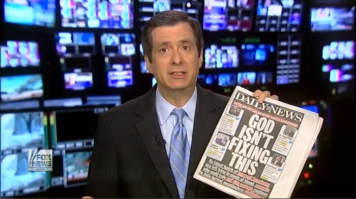 Fox News analyst Howard Kurtz holding up a copy of NY Daily News cover story reading 'God Isn't Fixing This,' published on December 3, 2015.