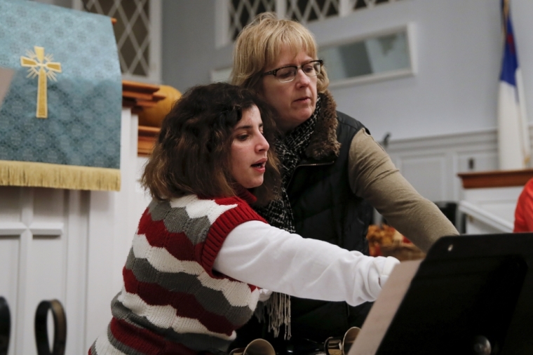 Sandy Khabbazeh (L) a Syrian refugee, takes part bell choir practice at her church in Oakland, New Jersey, November 19, 2015.