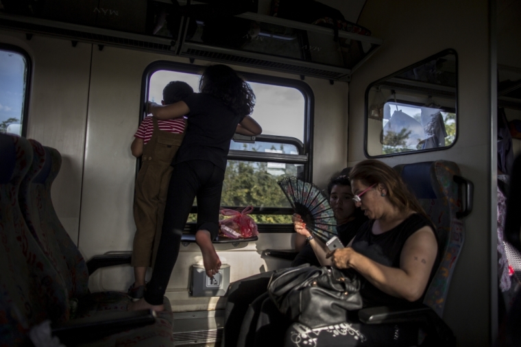 Fayza (R), 45, a Christian Iraqi migrant is seen inside a train with her children while travelling to Austria, crossing the border from Hungary September 14, 2015.