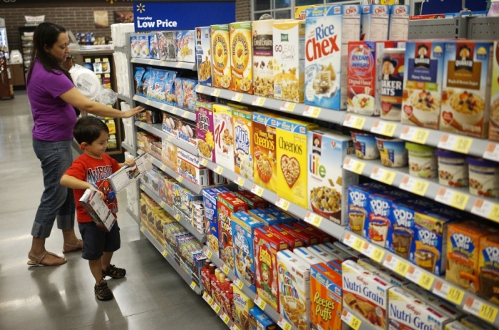 A woman and child shop at a Walmart to Go convenience store which is open on a trial basis in Bentonville, Arkansas, June 5, 2014. The new Walmart to Go stores will carry 3,500 of the products the regular Walmart stores carry at similar prices.