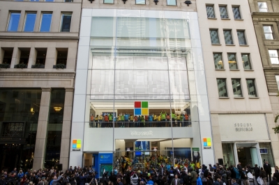 Store employees jump and cheer for the grand opening of a flagship Microsoft Corp. retail store in New York, October 26, 2015.