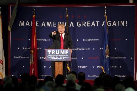 U.S. Republican presidential candidate Donald Trump points to a supporter at a Pearl Harbor Day rally aboard the USS Yorktown Memorial in Mount Pleasant, South Carolina, December 7, 2015. Trump on Monday called for a ban on Muslims entering the United States in the most dramatic response by a candidate yet to last week's shooting spree by two Muslims who the FBI said had been radicalized.