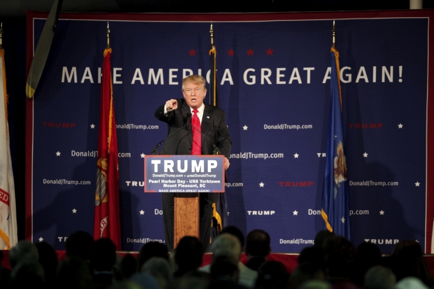 U.S. Republican presidential candidate Donald Trump points to a supporter at a Pearl Harbor Day rally aboard the USS Yorktown Memorial in Mount Pleasant, South Carolina, December 7, 2015. Trump on Monday called for a ban on Muslims entering the United States in the most dramatic response by a candidate yet to last week's shooting spree by two Muslims who the FBI said had been radicalized. 