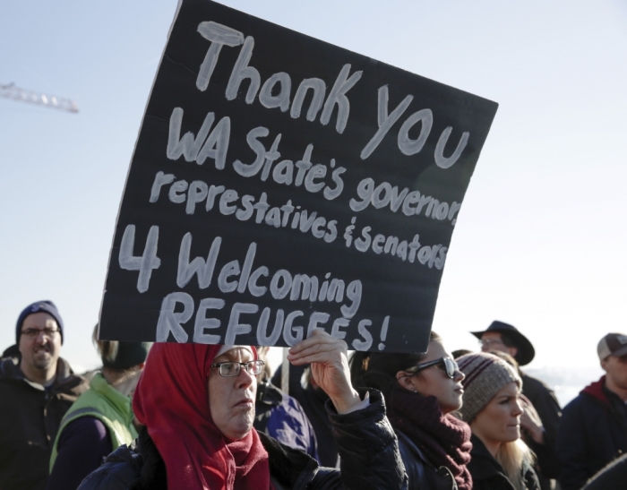 Janice Tufte of Seattle, a Muslim, participates in a pro-refugee protest organized by Americans for Refugees and Immigrants in Seattle, Washington, November 28, 2015.