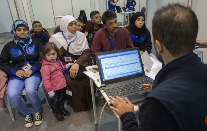 A family of Syrian refugees are being interviewed by authorities in hope of being approved for passage to Canada at a refugee processing centre in Amman, Jordan, November 29, 2015.
