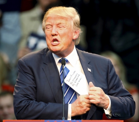 U.S. Republican presidential candidate Donald Trump puts his notes back in his jacket after talking about Democrat opponent Hillary Clinton at a Trump for President campaign rally in Raleigh, North Carolina December 4, 2015. The notes read, "Beat Hillary, No Strength, No Stamina, Goes Away".