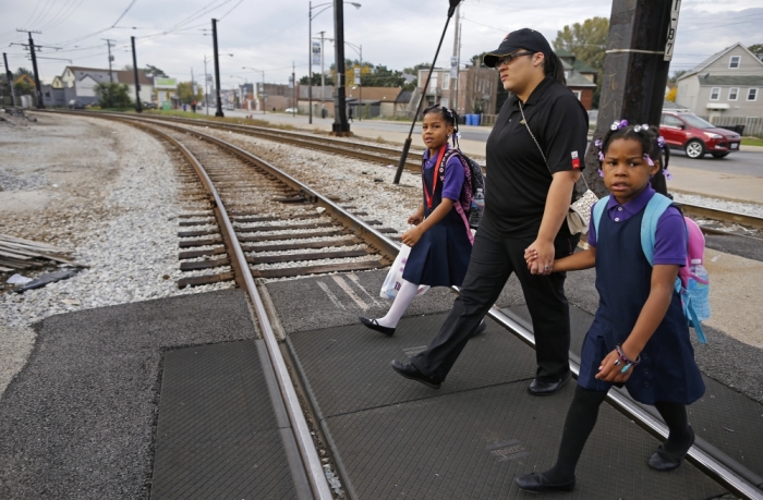 Delores Leonard (C) walks her daughters Emmarie (L) and Erin to school before heading to work at a McDonald's Restaurant in Chicago, Illinois, September 25, 2014. Leonard, a single mother raising two daughters, has been working at McDonald's for seven years and has never made more than minimum wage.