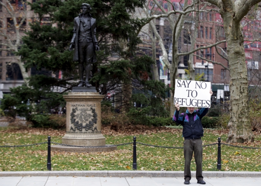 A supporter of U.S. Republican presidential candidate Donald Trump stands nearby during an interfaith rally at New York's City Hall in Manhattan December 9, 2015. Republican presidential front-runner Donald Trump's proposal to ban Muslims from entering the United States drew a growing wave of international criticism on Wednesday and cost him business in the Middle East.