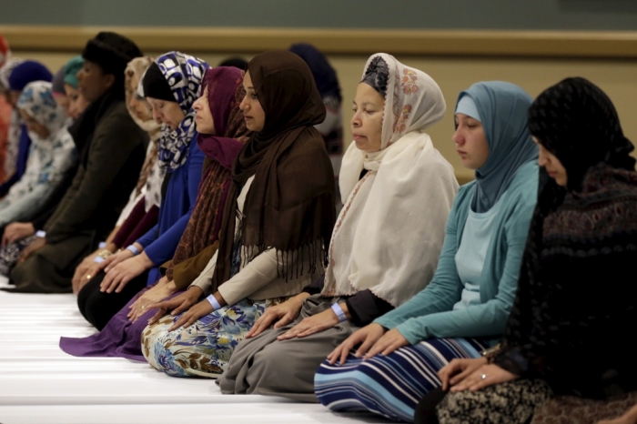 Women participate in a Maghrib prayer during a Muslim Public Affairs Council convention in Long Beach, California December 5, 2015.