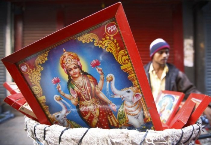 A poster of the Goddess of wealth Laxmi is seen for sale by a vendor along the streets of Kathmandu during the Tihar festival also called Diwali in Kathmandu, taken in 2013.