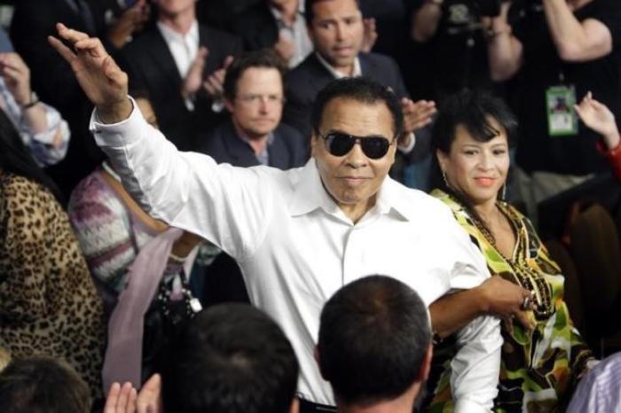 Muhammad Ali waves to the crowd after being introduced before the fight between Floyd Mayweather, Jr. and Shane Mosley.