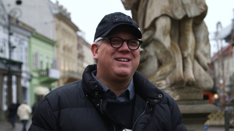 Television personality and radio host Glenn Beck smiles on a street in Slovakia.