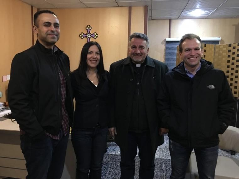 Humanitarian Johnnie Moore (far right) poses with Father Douglas Bazi (center right), and two colleagues.