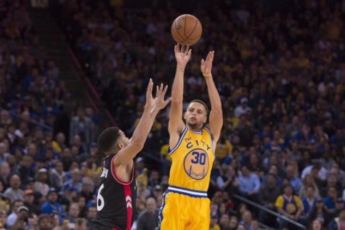 Steph Curry of the Golden State Warriors shoots against Cory Joseph of the Toronto Raptors.