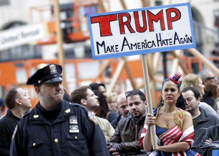 People take part in an anti-Donald Trump, pro-immigration protest outside the Plaza Hotel, where U.S. Republican presidential candidate Donald Trump spoke, in the Manhattan borough of New York December 11, 2015.