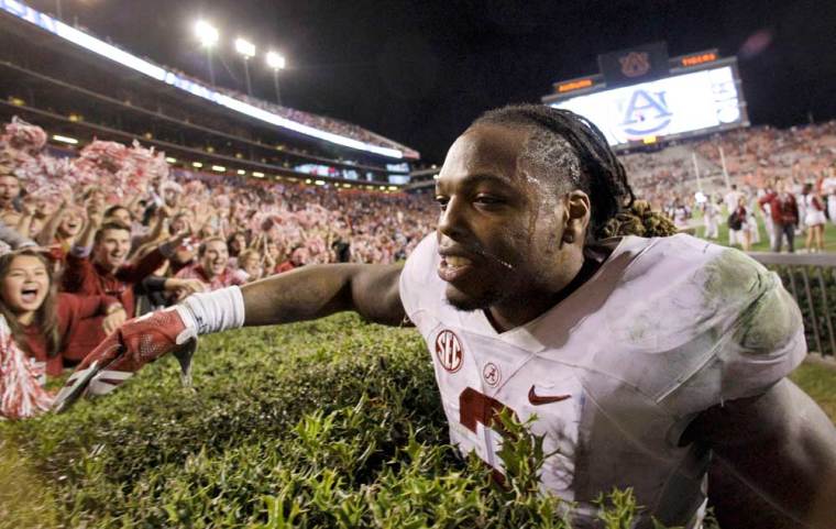 Alabama Crimson Tide running back Derrick Henry (2) celebrates with fans after beating the Auburn Tigers 29-13 Jordan Hare Stadium.