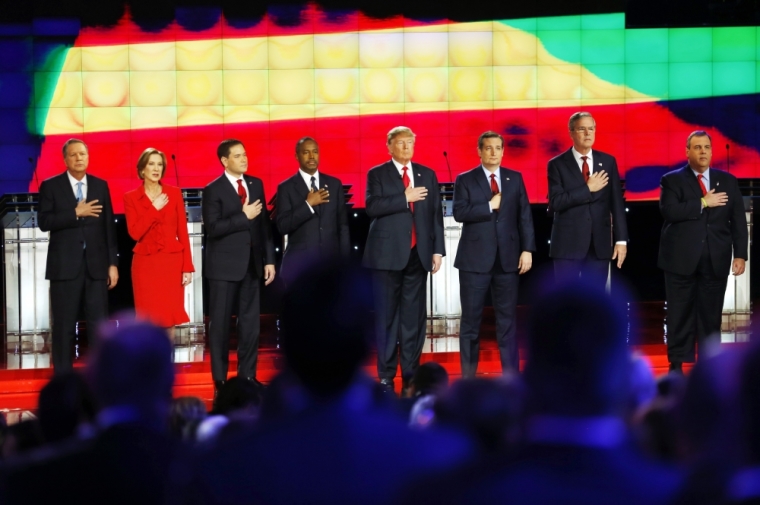 Republican U.S. presidential candidates (L-R) Governor John Kasich, former HP CEO Carly Fiorina, Senator Marco Rubio, Dr. Ben Carson, businessman Donald Trump, Senator Ted Cruz, former Governor Jeb Bush, Governor Chris Christie and Senator Rand Paul hold their hands over their hearts for the singing of the U.S. national anthem before the start of the Republican presidential debate in Las Vegas, Nevada December 15, 2015.