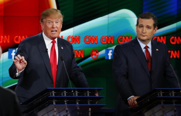 Republican U.S. presidential candidate businessman Donald Trump (L) speaks as Senator Ted Cruz looks on during the Republican presidential debate in Las Vegas, Nevada December 15, 2015.