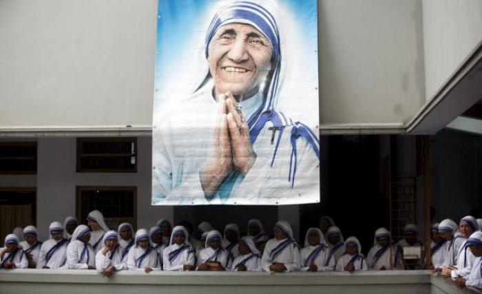 Catholic nuns from the order of the Missionaries of Charity gather under a picture of Mother Teresa during the tenth anniversary of her death in Kolkata, India, in this September 5, 2007 file photo.