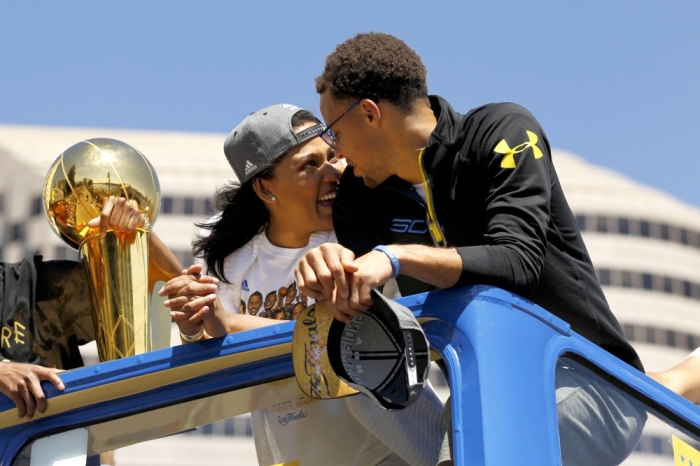 Jun 19, 2015; Oakland, CA, USA; Golden State Warriors guard Stephen Curry talks with his wife Ayesha Curry during the Golden State Warriors 2015 championship celebration in downtown Oakland.