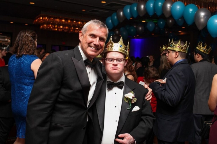 A guest and event host pose for cameras at the Night to Shine prom co-hosted by Liquid Church and sponsored by the Tim Tebow Foundation, Morristown, New Jersey, February 13, 2015.