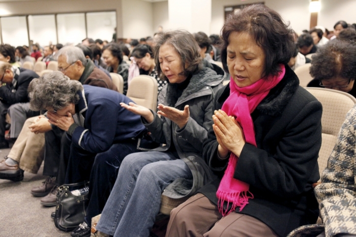 Participants pray for Canadian Pastor Hyeon Soo Lim who is being held in North Korea during a joint multi-cultural prayer meeting at Light Korean Presbyterian Church in Toronto, December 20, 2015. Canadian diplomats were allowed to meet detained pastor Lim on Friday, after he was sentenced to life in prison in North Korea earlier last week, and found him in good spirits and health, a church spokeswoman said on Sunday.