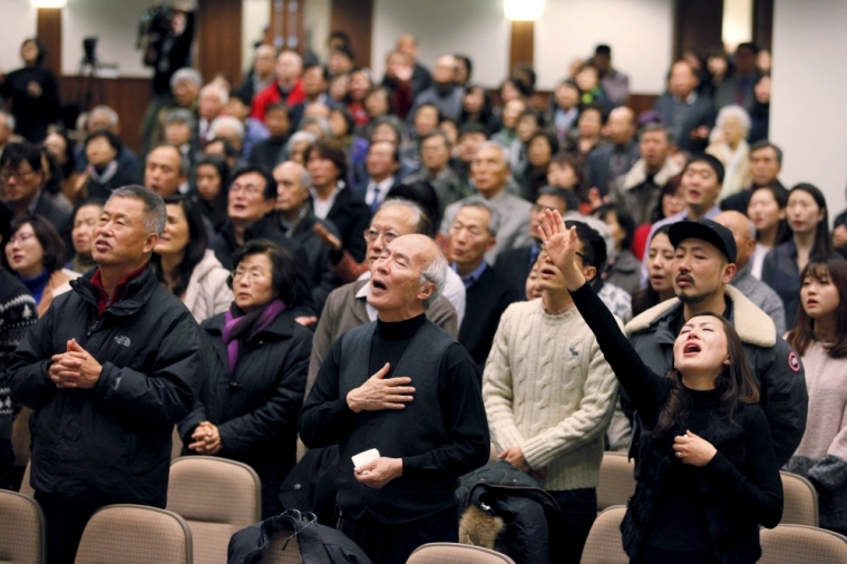 Participants pray for Canadian Pastor Hyeon Soo Lim who is being held in North Korea during a joint multi-cultural prayer meeting at Light Korean Presbyterian Church in Toronto, December 20, 2015. Canadian diplomats were allowed to meet detained pastor Lim on Friday, after he was sentenced to life in prison in North Korea earlier last week, and found him in good spirits and health, a church spokeswoman said on Sunday.