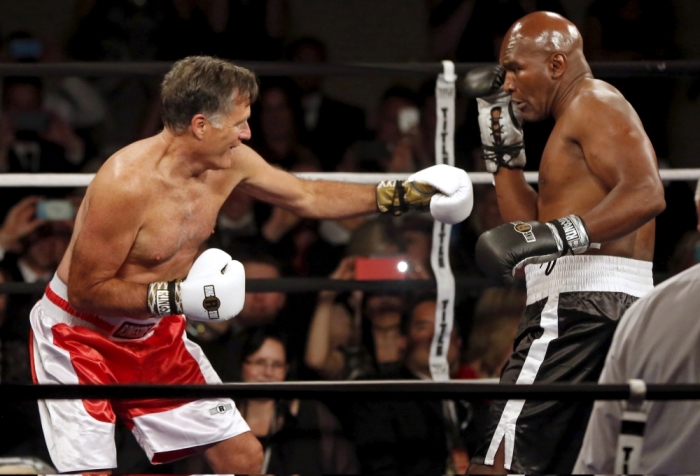 Former Massachusetts Governor and two-time presidential candidate Mitt Romney (L) fights five-time heavyweight champion Evander Holyfield during their boxing match in Salt Lake City, Utah May 15, 2015. The two boxed to benefit the medical charity CharityVision.