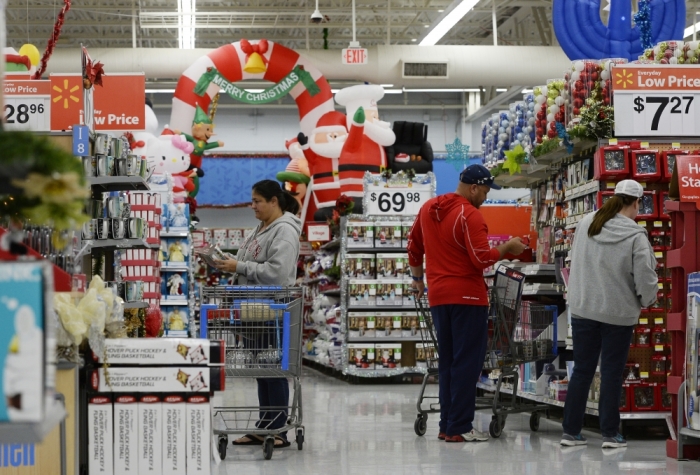 Customers shop for Christmas ornaments at a Walmart store in the Porter Ranch section of Los Angeles, November 26, 2013. This year, Black Friday starts earlier than ever, with some retailers, including Wal-Mart, opening early on Thanksgiving evening. About 140 million people were expected to shop over the four-day weekend, according to the National Retail Federation.