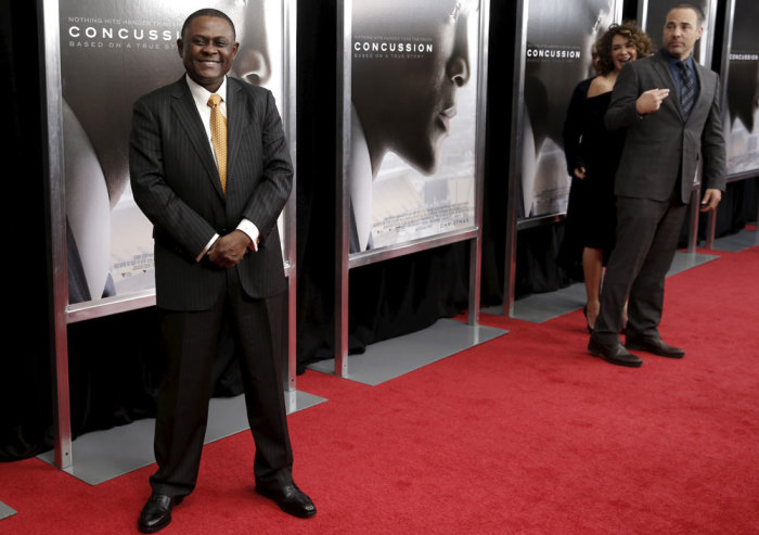 Forensic neuropathologist Dr. Bennet Omalu poses as he arrives for the New York premiere of the film 'Concussion' in the Manhattan borough of New York City, December 16, 2015. 'Concussion', which stars Will Smith portraying Omalu, the neuropathologist who a decade ago first linked brain damage to the deaths of National Football League (NFL) players, opens nationwide December 25, 2015. At right is writer director Peter Landesman.