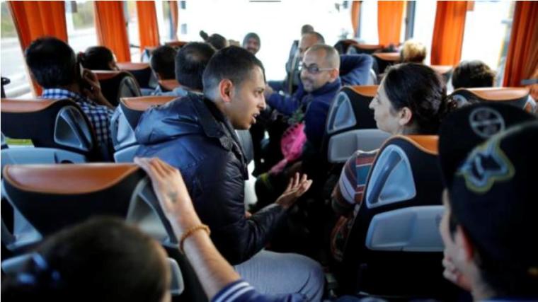 Christian Syrian refugees travel in a bus which transports fifteen members of the same family who arrived at the Charles-de-Gaulle International Airport in Roissy, October 2, 2015.