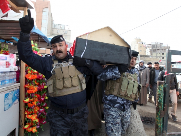 Mourners carry the coffin of a member from the Iraqi security forces, who was killed in the city of Ramadi, during a funeral in Najaf, south of Baghdad, Iraq.