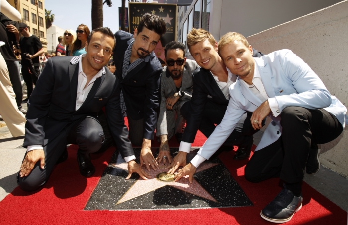 Backstreet Boys (from L-R) Howie Dorough, Kevin Richardson, A. J. McLean, Nick Carter and Brian Littrell touch their star after it was unveiled on the Walk of Fame in Los Angeles, California, April 22, 2013.
