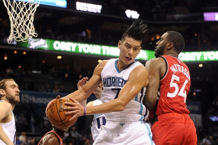 Dec 17, 2015; Charlotte, NC, USA; Charlotte Hornets guard Jeremy Lin (7) fights Toronto Raptors forward Patrick Patterson (54) for the rebound during the first half of the game at Time Warner Cable Arena.