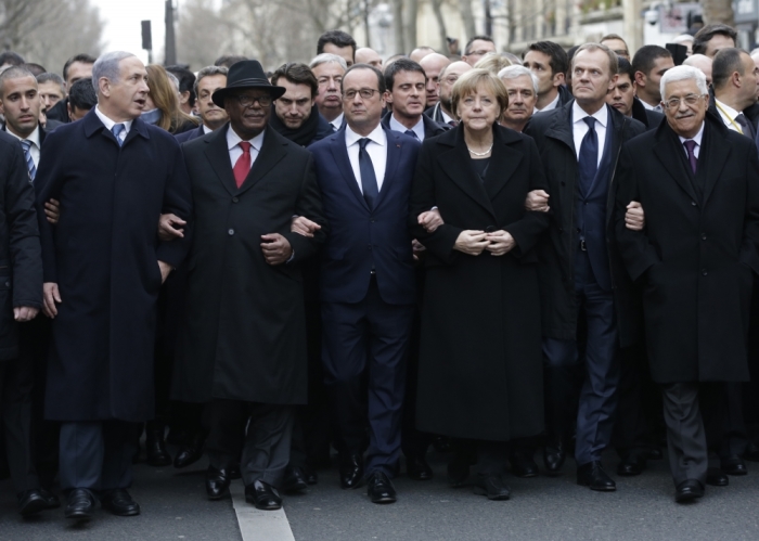 French President Francois Hollande is surrounded by head of states including (L to R) Israel's Prime Minister Benjamin Netanyahu, Mali's President Ibrahim Boubacar Keita, Germany's Chancellor Angela Merkel, European Council President Donald Tusk and Palestinian President Mahmoud Abbas as they attend the solidarity march (Marche Republicaine) in the streets of Paris January 11, 2015. French citizens will be joined by dozens of foreign leaders, among them Arab and Muslim representatives, in a march on Sunday in an unprecedented tribute to this week's victims following the shootings by gunmen at the offices of the satirical weekly newspaper Charlie Hebdo, the killing of a police woman in Montrouge, and the hostage taking at a kosher supermarket at the Porte de Vincennes.