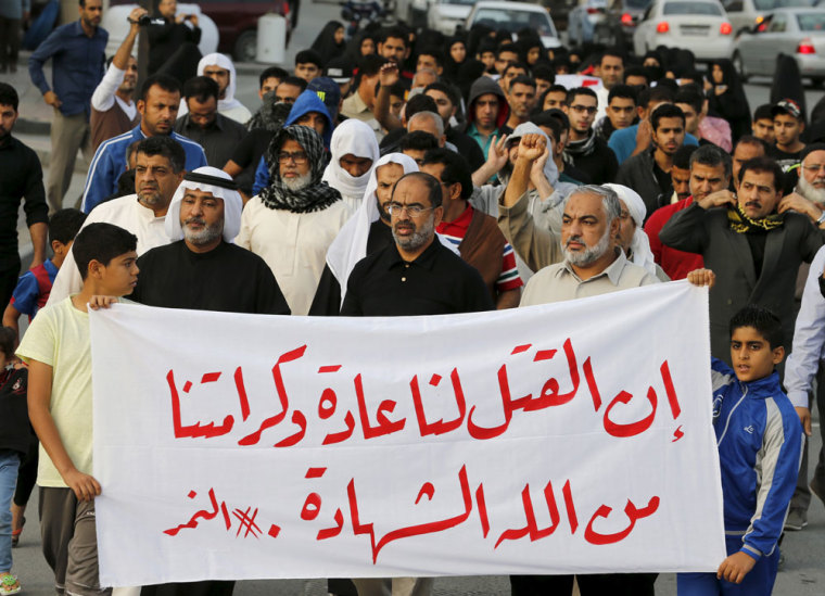 Protesters holding a banner saying 'Death is normal to us and our dignity from God is martyrdom' take part in a protest against the execution of Saudi Shi'ite cleric Nimr al-Nimr by Saudi authorities, in the village of Sanabis, west of Manama, Bahrain January 2, 2016.