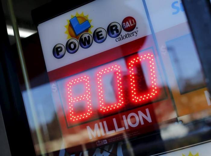 A corner store displays a Powerball lottery sign next to its cash register and checkout in Encinitas, California January 8, 2016. The jackpot in the Powerball lottery, already the largest ever payout in North American history, continued to climb, hitting an estimated 0 million on Friday, the operator of the multistate game said.