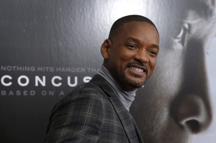 Actor Will Smith poses as he arrives for the New York premiere of the film 'Concussion' in the Manhattan borough of New York City, December 16, 2015. 'Concussion', which stars Smith portraying Dr. Bennet Omalu, the pathologist who a decade ago first linked brain damage to the deaths of National Football League (NFL) players, opens nationwide December 25.