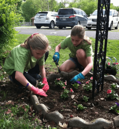 Volunteers do gardening work at a group home in Tennessee as part of an ecumenical community service event titled 'Mission Blitz.'