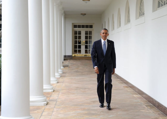 U.S. President Barack Obama walks down the colonnade from the Oval Office at The White House in Washington, January 12, 2016.