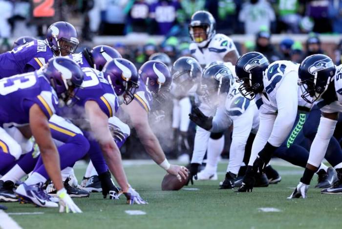 Breath from the linemen of the Minnesota Vikings and Seattle Seahawks are seen as they line up in the fourth quarter of a NFC Wild Card playoff football game at TCF Bank Stadium in Minneapolis, Minnesota, January 10, 2016.