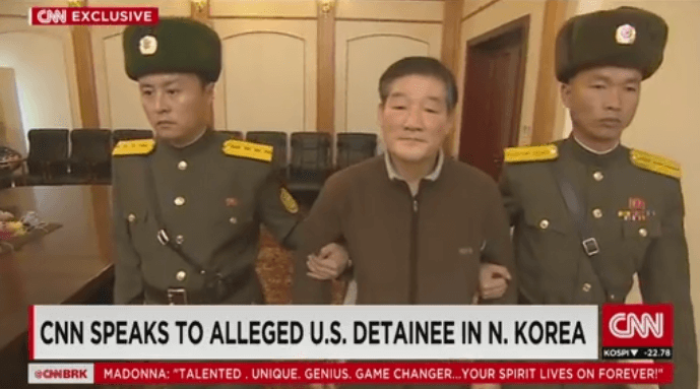 Korean-American citizen Kim Dong Chul being led into a room by two North Korean officials to be interviewed by CNN about his arrest and detention inside Pyongyang, North Korea in this undated video.
