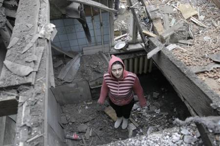 A woman stands in her house, which was damaged by recent shelling, in central Donetsk, eastern Ukraine, February 2, 2015. Artillery attacks on the Ukrainian city of Donetsk killed at least one civilian on Monday while Kiev's military reported that five more Ukrainian soldiers had been killed in clashes with separatists in the east in the past 24 hours.
