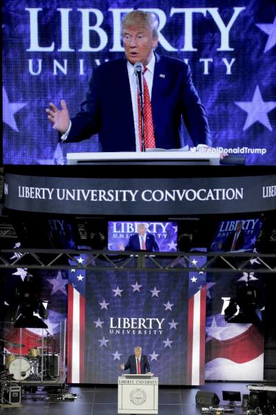 U.S. Republican presidential candidate Donald Trump is shown on a big screen as he speaks at Liberty University in Lynchburg, Virginia, January 18, 2016.