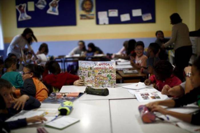 Children do their homework while attending a programme that gives children academic and psychological help to improve their chances in life, at a Catholic charity Caritas centre in the neighborhood of Puente Tocinos, near Murcia, southeast Spain, November 3, 2015.
